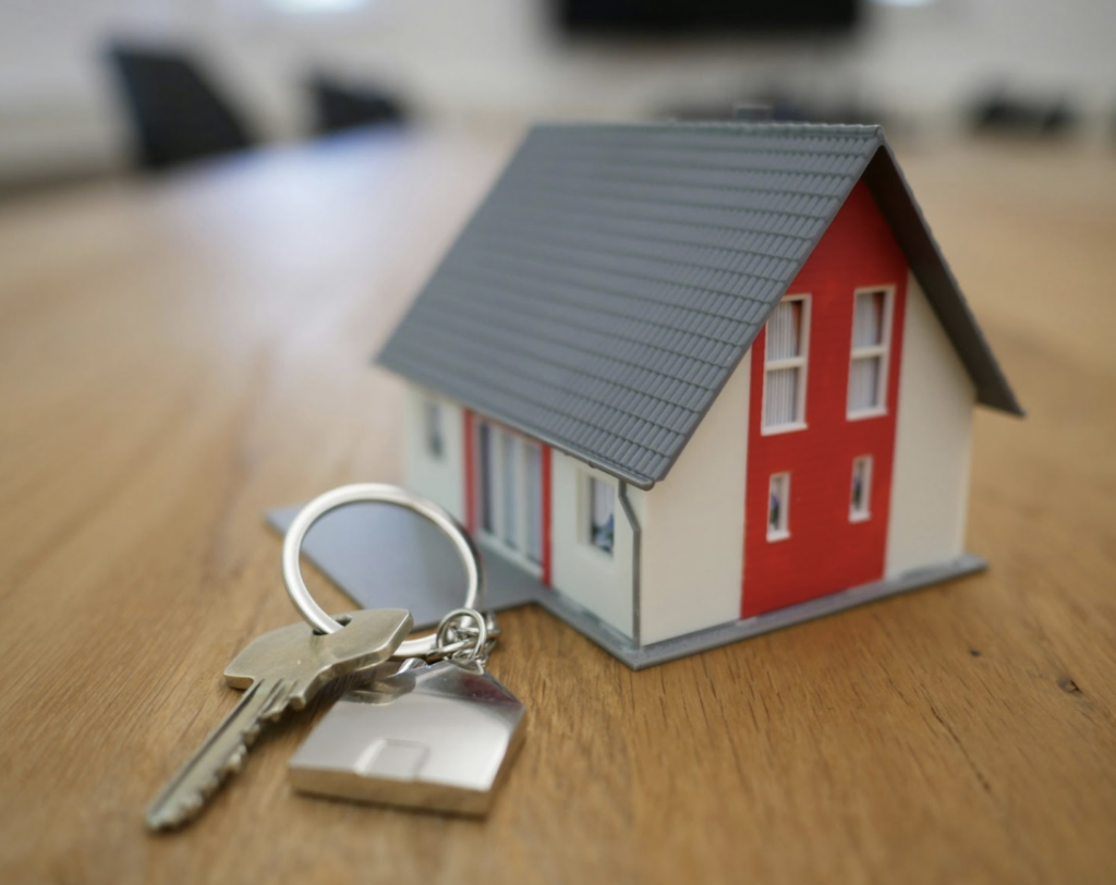 Keys Sitting Next to a Toy House